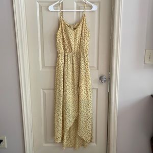 Flowing asymmetrical yellow summer dress.